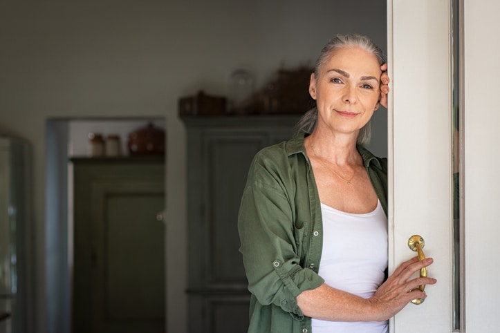 Mature woman standing at door