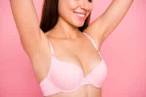 A closeup shot of a woman wearing a pink bra