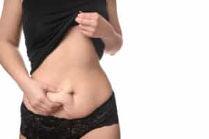 Woman in black underwear grabs extra belly fat in Boca Raton