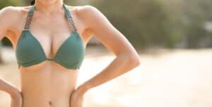 Woman enjoying symmetrical breast appearance after breast surgery in Boca Raton, FL